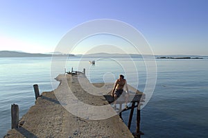 Traveler relaxing at old quay