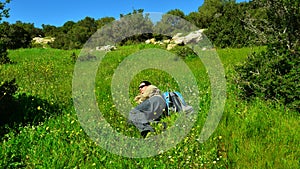 Traveler rests in grass