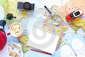 Traveler`s accessories and items with copy space on world map background, travel by car concept.