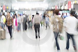 Traveler silhouettes in motion blur, airport interior