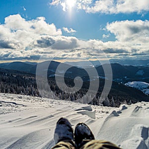 Traveler sitting on mountain peak. Panoramic view from mountain Zakhar Berkut, Carpathian mountains, Ukraine photo