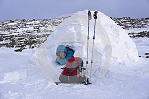 Traveler in a snowy house igloo