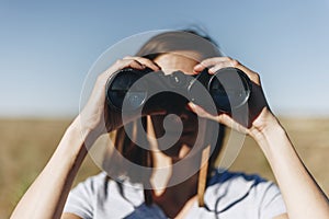 Traveler spying through binoculars