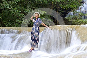 Traveler stand relax in waterfall  at Erawan Waterfall and  natura