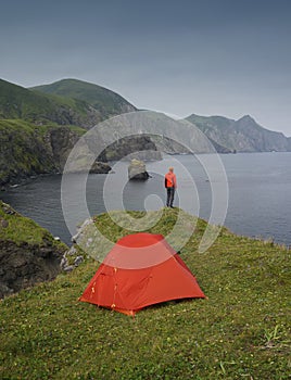 Traveler Standing on the Cliff and Looking at the Pacific Ocean Coastline on Shikotan Island, Lesser Kuril Chain