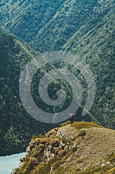 Traveler standing on cliff mountain adventure travel vacations outdoor