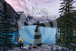 Traveler standing on Moraine lake with Canadian rockies in Banff national park