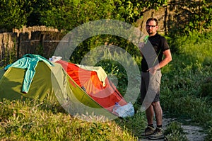 Traveler standing next to his tent