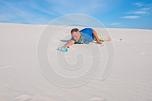 Traveler suffering from thirst, is crawling through the desert