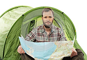 Traveler in a tent with a map