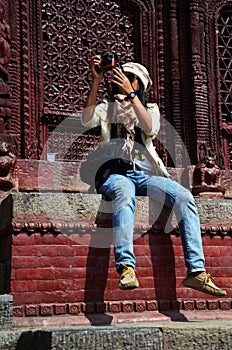 Traveler thai women photographer travel visit and work take photo ancient nepalese architecture and antique old ruin nepali royal