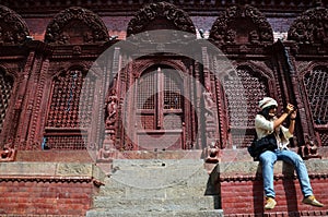 Traveler thai women photographer travel visit and work take photo ancient nepalese architecture and antique old ruin nepali royal