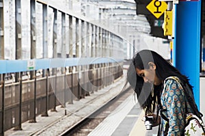 Traveler thai women standing and posing at front of track of Saitama Rapid Railway