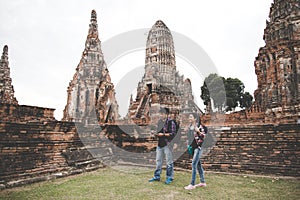 Traveler and tourist asian man and women with backpack walking in temple Ayuttaya ,Thailand.