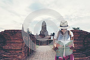 Traveler and tourist asian women check map with backpack walking in temple Ayuttaya ,Thailand.