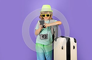 Traveler tourist kid boy 7-8 years old on isolated studio background. Travel on weekends getaway. Independent kid boy