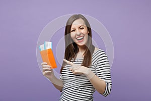 Traveler tourist woman girl in casual striped clothes posing isolated on violet purple background studio portrait