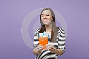 Traveler tourist woman girl in casual striped clothes posing isolated on violet purple background studio portrait