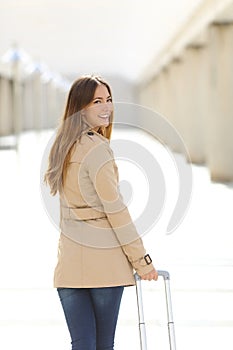 Traveler tourist woman walking and looking at camera in an airport