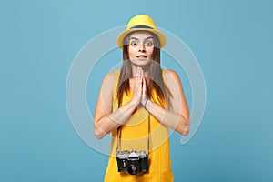 Traveler tourist woman in yellow summer casual clothes, hat with photo camera isolated on blue background. Female