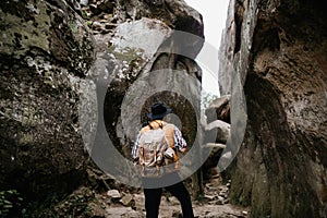 Traveler travels in the mountains with a backpack. Active recreation in nature
