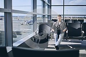 Traveler using laptop in airport terminal