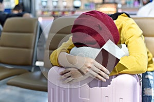 Traveler waiting and sleeping at the area lounge airport terminal, Passenger tired for delayed boarding flight.