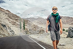 Traveler walks on the mountain road in indian Himalaya