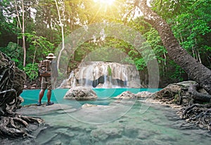 Traveler is watching beautiful scene nature background from Earawan Waterfalls in Kanchanburi, Thailand