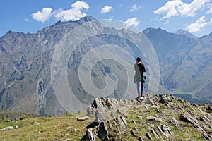 A traveler watching on mountain landscape, Kazbeg mountain - Kazbegi (Stepantsminda), Georgia photo