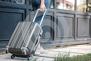 Traveler woman carrying luggage. Tourist walking with Suitcases Travel lifestyle concept