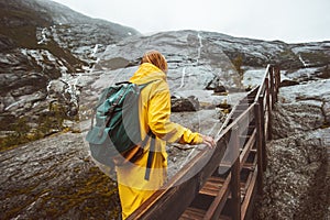 Traveler woman climbing up stairs in rocky mountains