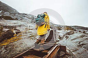 Traveler woman climbing up stairs in scandinavian mountains