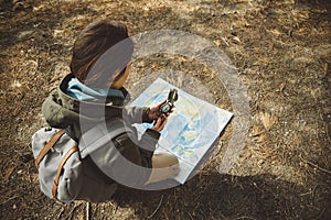 Traveler woman with a compass and map outdoor