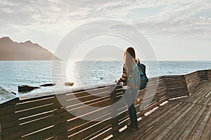 Traveler woman contemplating standing alone on bridge