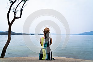 Traveler woman enjoy looking at beautiful lake with mountains on background