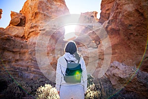 Traveler woman enjoy picturesque mountains in canyon backlit by