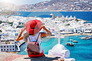 Traveler woman enjoys the view over the town of Mykonos island, Cyclades, Greece