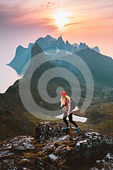 Traveler woman hiking alone on a trail in Norway outdoor travel summer vacations healthy lifestyle active girl with backpack