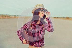 Traveler woman looks through binoculars