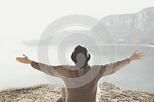 Woman with open arms hugging the surrounding nature photo