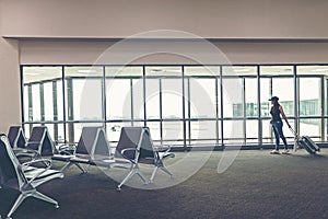 Traveler woman plan and backpack see the airplane at the airport glass window, girl tourist hold bag and waiting near luggage in h