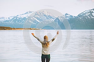 Traveler woman raised hands enjoying mountains view