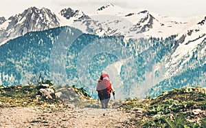 Traveler woman with red backpack mountaineering