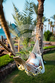 Traveler woman relax in hammock on summer beach