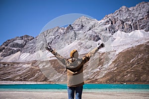 Traveler woman standing in freedom with arms up happy and looking beautiful view at outdoor,Travel concept,Back view