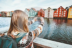 Traveler woman taking photo by smartphone sightseeing Trondheim city