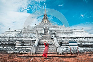 Traveler woman travel in Wat Phu Khao Thong pagoda temple at Ayutthaya historical park Thailand