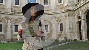 Traveler woman wlak while holding a maps looking, admiring and smiling