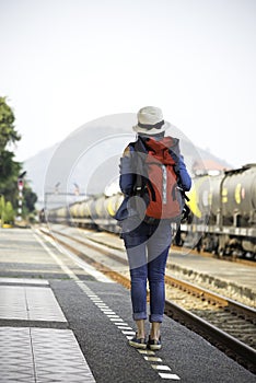 Traveler women walking alone Carrying luggage and waits train